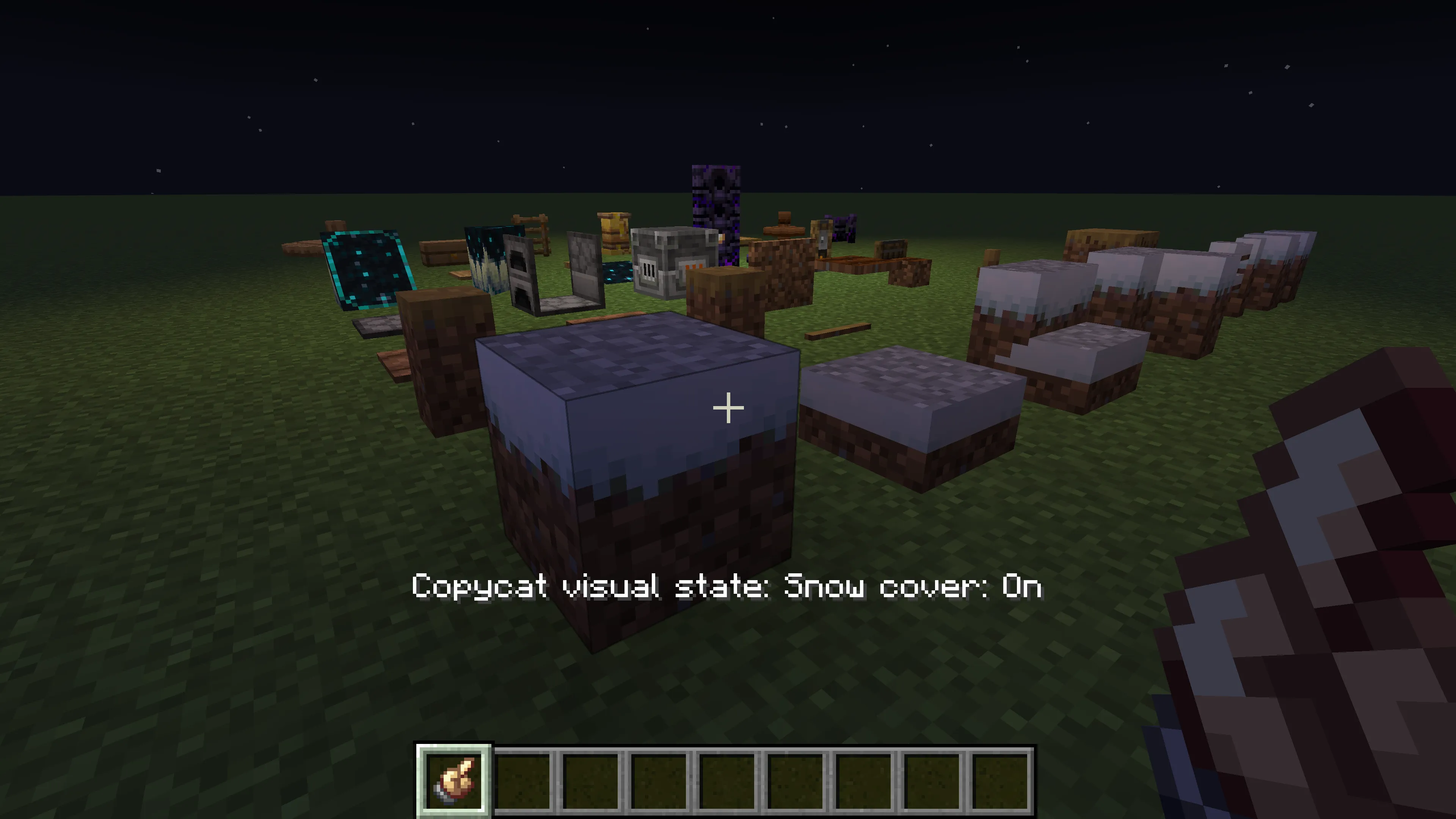 A Minecraft player using the Brass Hand to change a copycat block's snow state